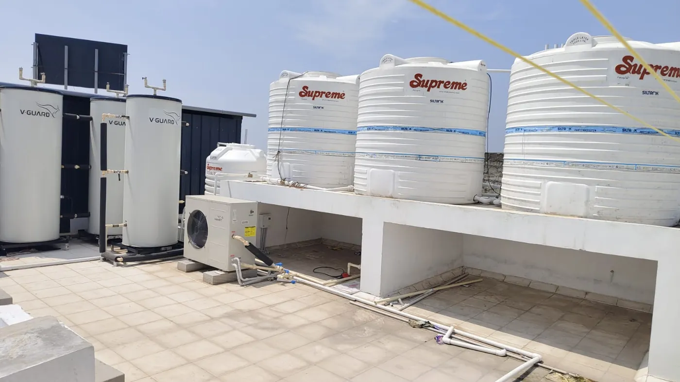 Solar water heaters and water tanks on the terrace at KPR Nest