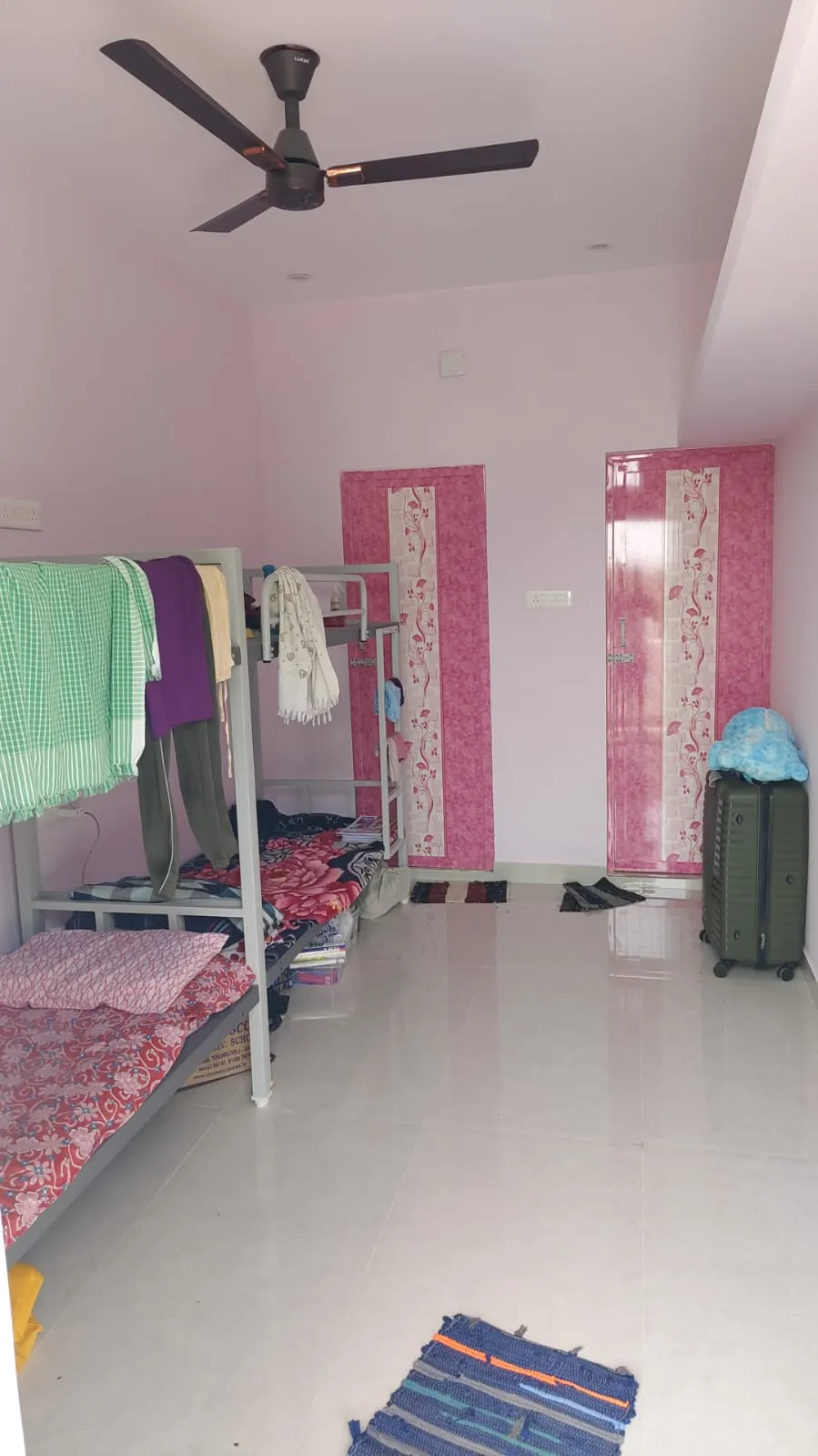 Room at Lovely Nest with cots and wardrobe